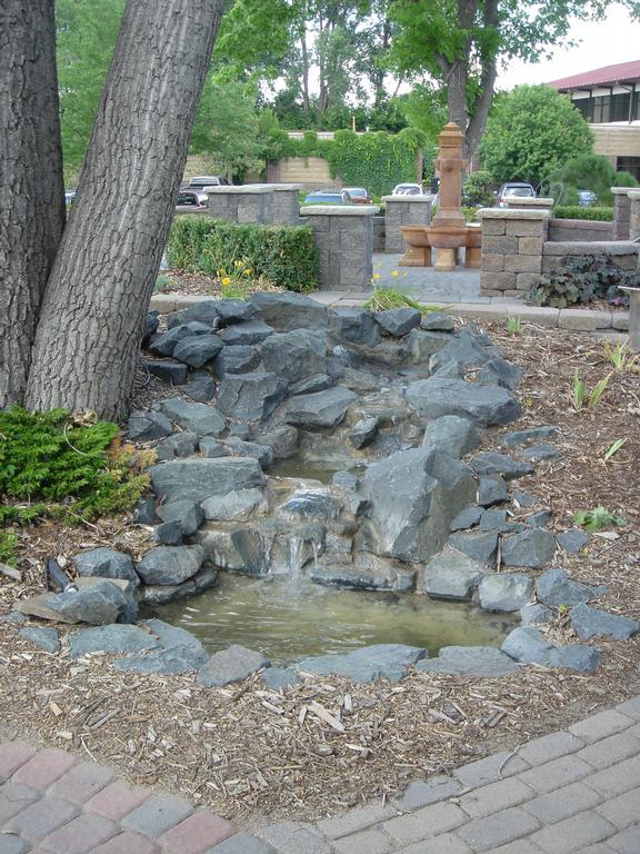 Natural stone water features fill the air with soothing sounds from